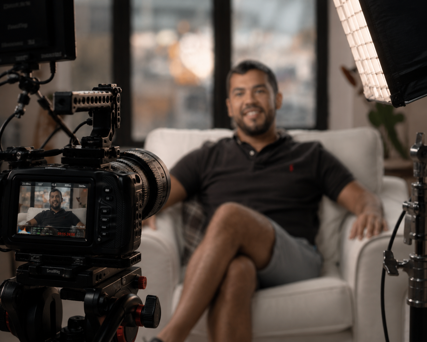 Cinema camera framed on a patient during a documentary interview in a sunlit living room